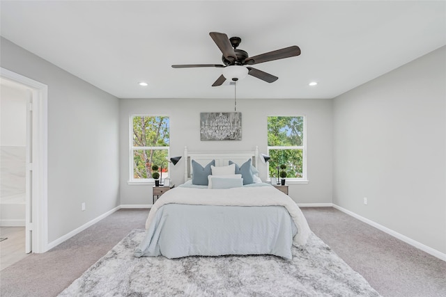 bedroom featuring carpet flooring, ceiling fan, and ensuite bathroom