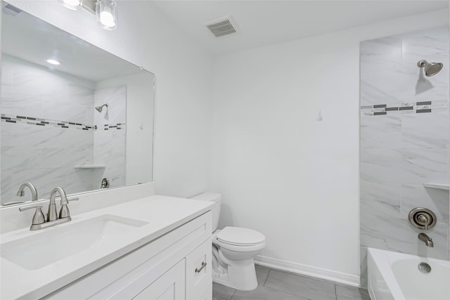 full bathroom featuring tile patterned flooring, toilet, vanity, and tiled shower / bath