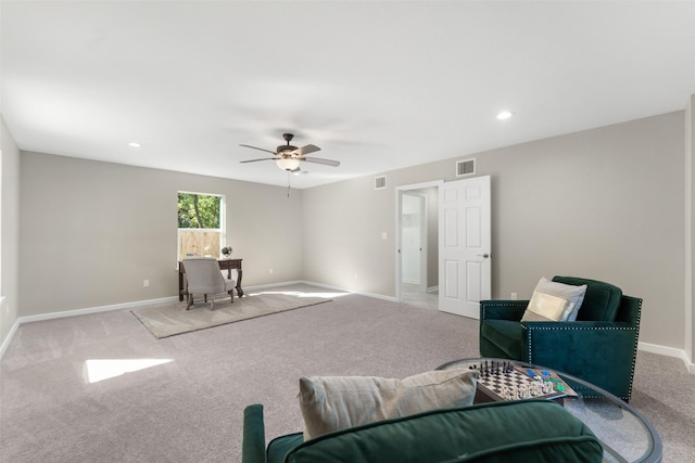 living area featuring ceiling fan and light carpet