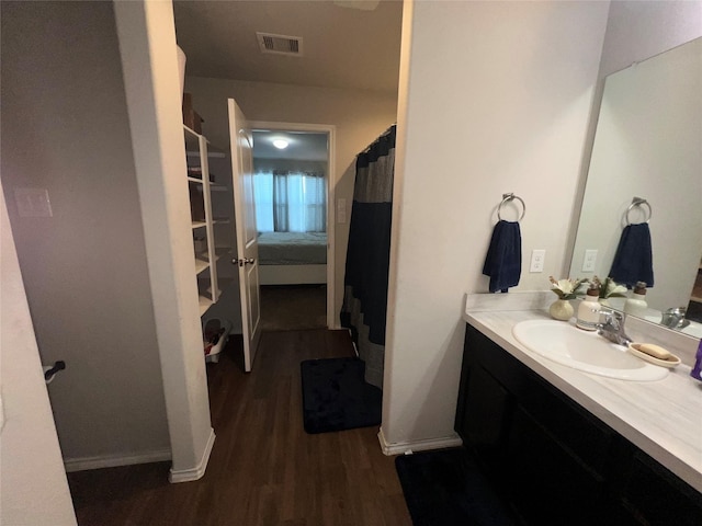 bathroom with hardwood / wood-style floors and vanity