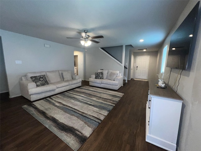 living room featuring ceiling fan and dark hardwood / wood-style flooring