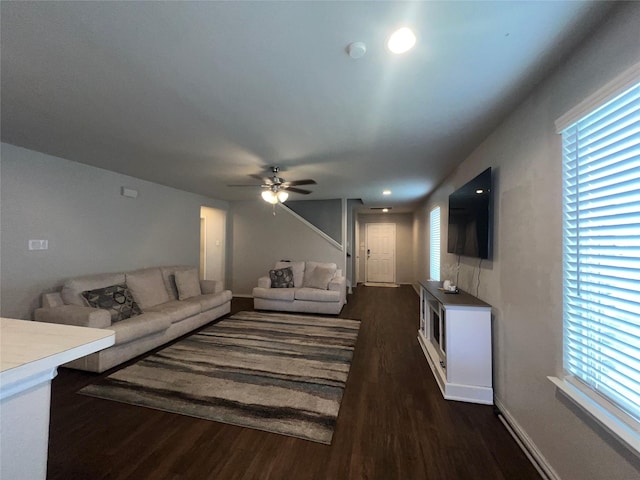 living room with ceiling fan and dark hardwood / wood-style flooring