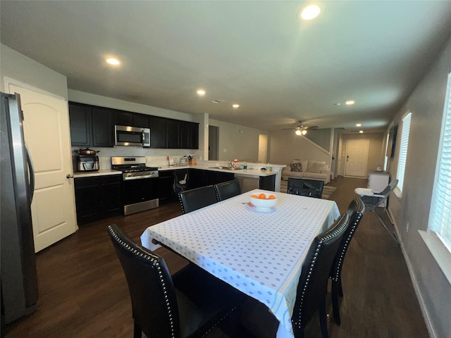 dining area featuring ceiling fan, dark hardwood / wood-style flooring, and sink