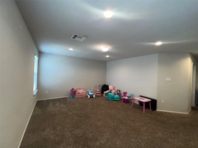 rec room with dark colored carpet