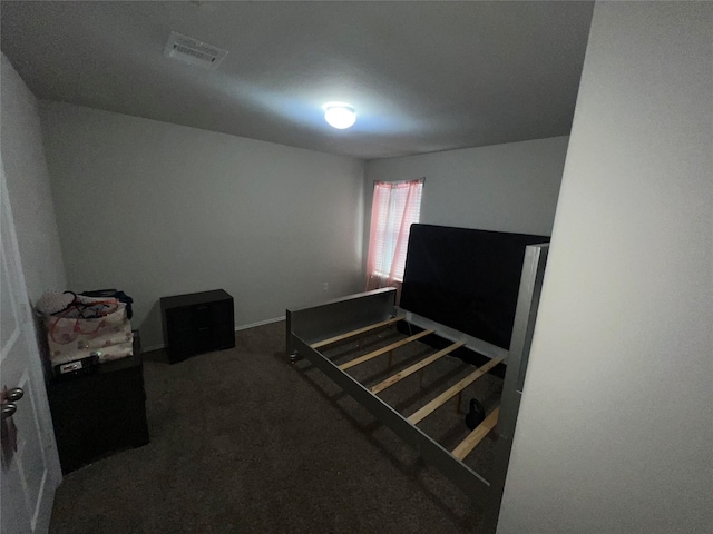 bedroom featuring dark carpet