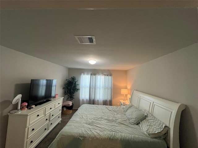 bedroom with dark colored carpet