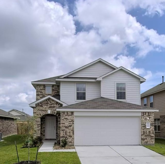 view of front property featuring a front yard and a garage