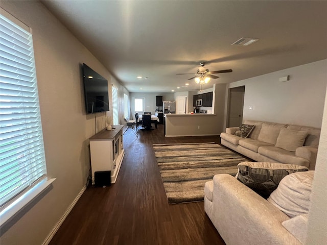 living room with dark hardwood / wood-style floors and ceiling fan