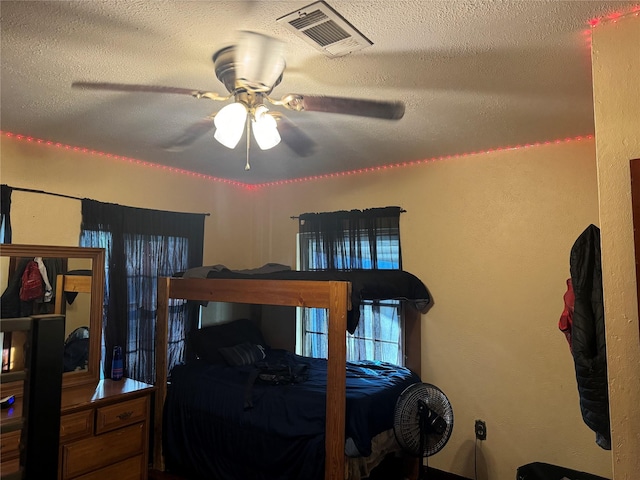 bedroom with a textured ceiling and ceiling fan