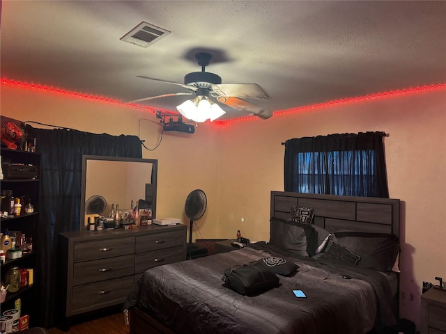 bedroom with ceiling fan and dark wood-type flooring