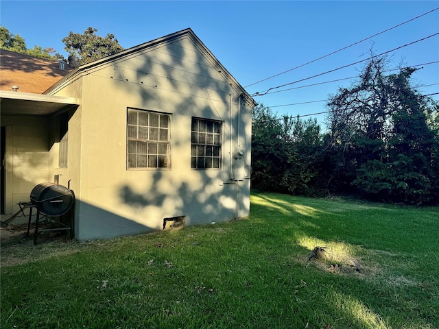 view of property exterior featuring a lawn