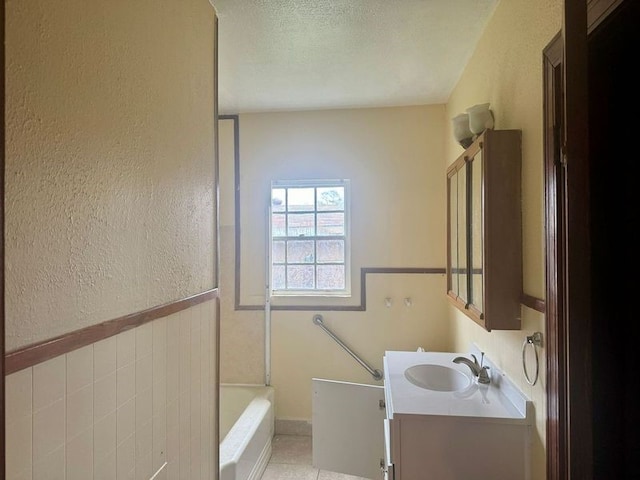 bathroom with vanity, bathing tub / shower combination, a textured ceiling, and tile patterned floors