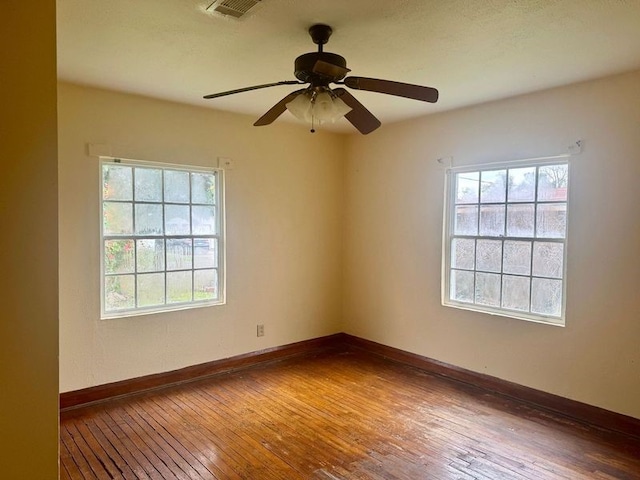 spare room featuring hardwood / wood-style floors and ceiling fan