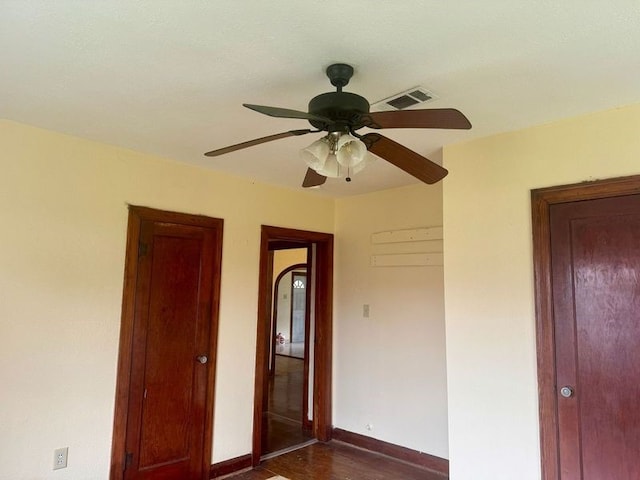 unfurnished bedroom with ceiling fan and dark hardwood / wood-style flooring