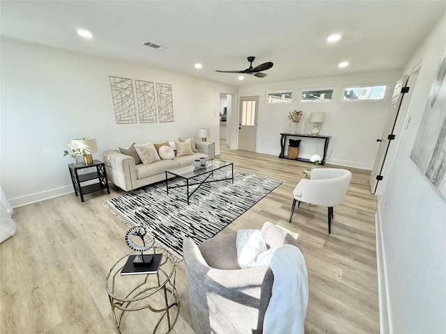 living room with light hardwood / wood-style floors and ceiling fan