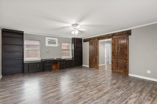 unfurnished living room featuring ornamental molding, a barn door, and dark wood-type flooring