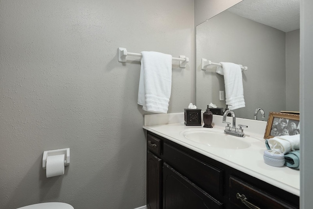 bathroom with vanity and a textured ceiling