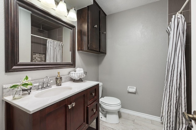 bathroom with vanity, a shower with shower curtain, a textured ceiling, and toilet