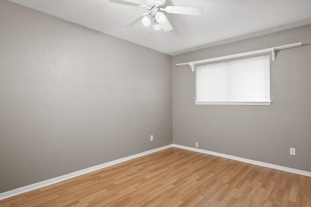 spare room featuring wood-type flooring, a textured ceiling, and ceiling fan