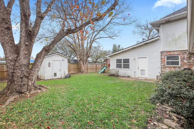 view of yard with a playground and a storage shed