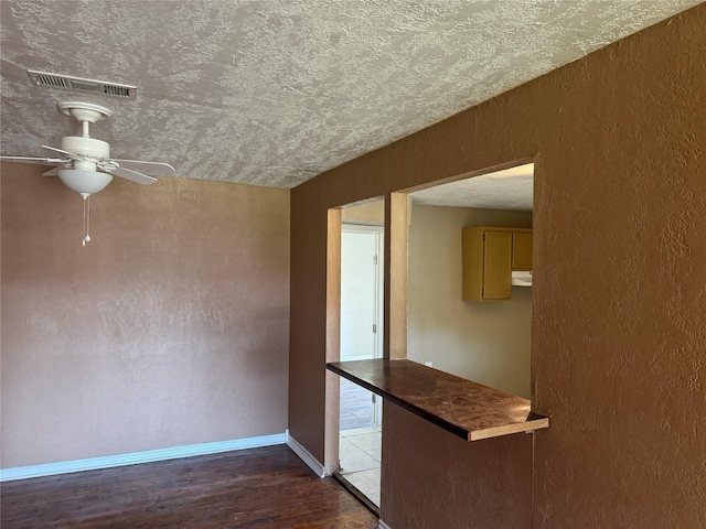 interior space featuring hardwood / wood-style floors, a textured ceiling, and ceiling fan