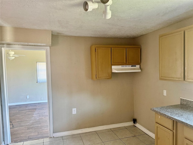 washroom with light tile patterned floors, a textured ceiling, and ceiling fan