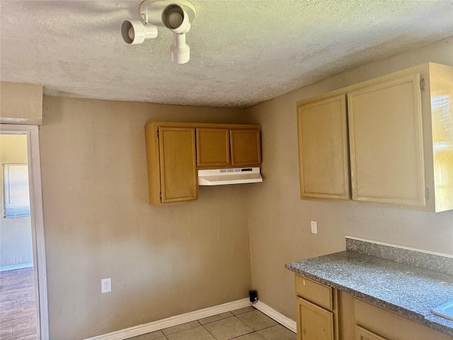 washroom featuring light tile patterned floors and a textured ceiling