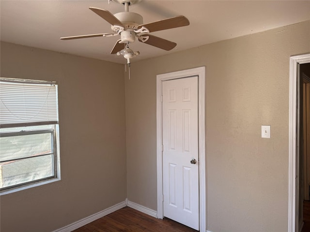 unfurnished bedroom with ceiling fan and dark hardwood / wood-style floors