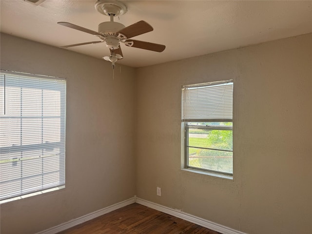 spare room with dark hardwood / wood-style floors and ceiling fan