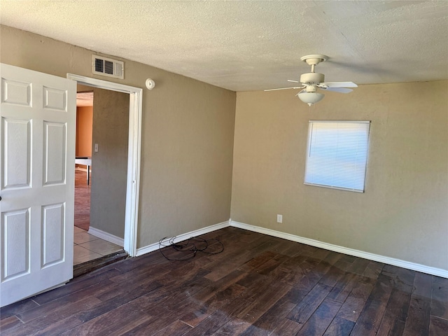 empty room with a textured ceiling, ceiling fan, and dark wood-type flooring