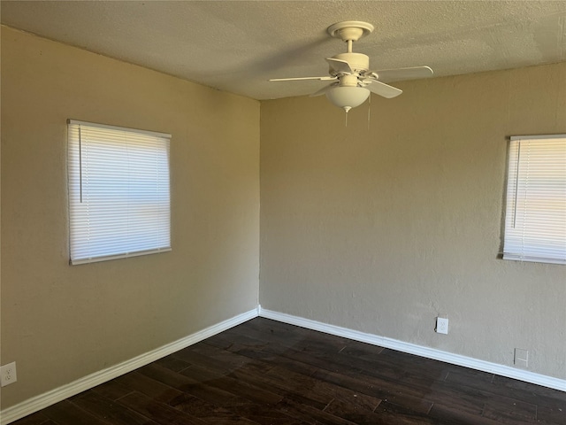 empty room with ceiling fan, dark hardwood / wood-style floors, and a textured ceiling