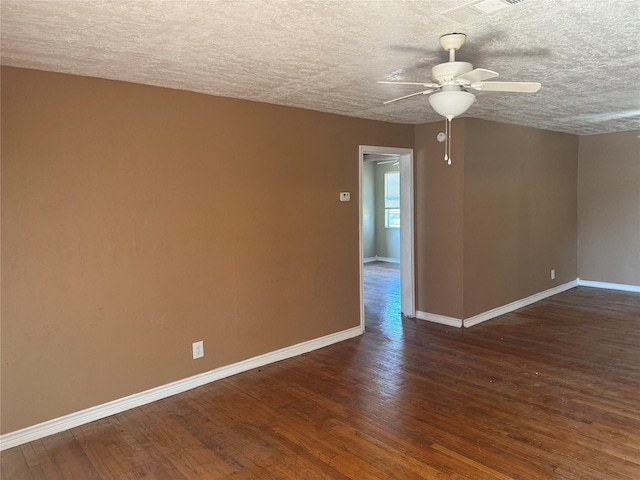 empty room featuring a textured ceiling, ceiling fan, and dark hardwood / wood-style floors