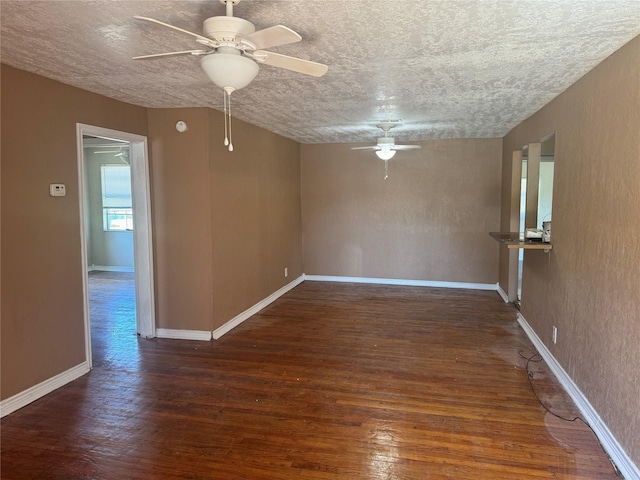 spare room with ceiling fan, dark wood-type flooring, and a textured ceiling