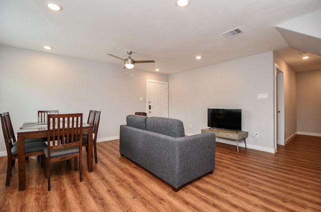 living area with light wood-type flooring, visible vents, baseboards, and recessed lighting