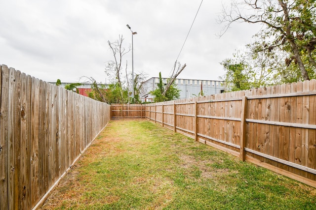 view of yard with a fenced backyard