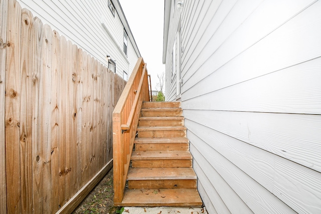 staircase with wood walls