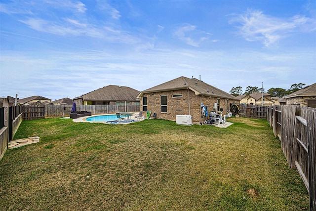 view of yard featuring a patio area and a fenced in pool