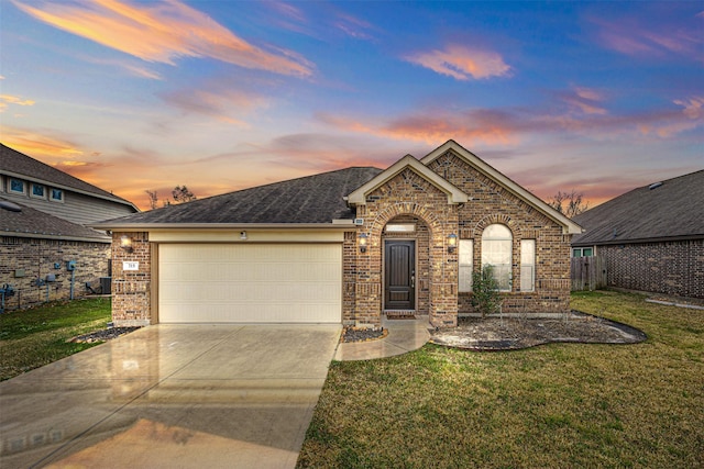 view of front of house with a garage and a lawn