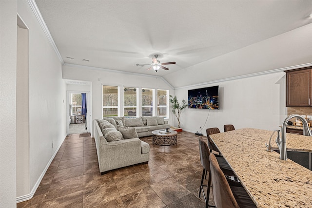 living room with sink, ceiling fan, vaulted ceiling, and crown molding