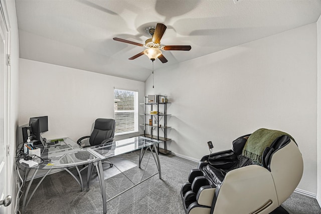 carpeted office featuring lofted ceiling and ceiling fan