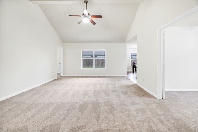 unfurnished living room with ceiling fan, high vaulted ceiling, and light colored carpet