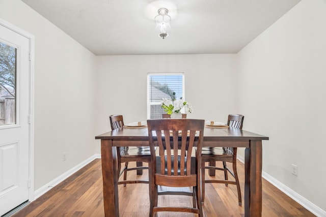 dining space with dark wood-type flooring