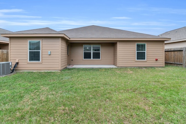 rear view of property with a lawn, central AC, and a patio