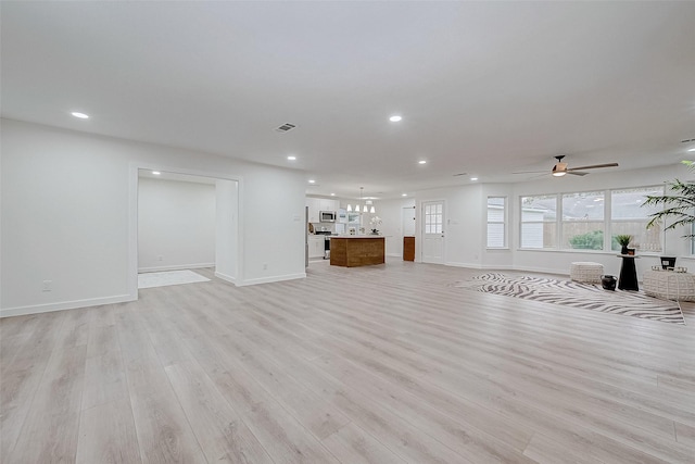 unfurnished living room featuring light hardwood / wood-style flooring and ceiling fan