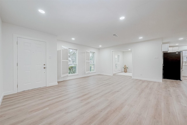 unfurnished living room featuring light wood-type flooring