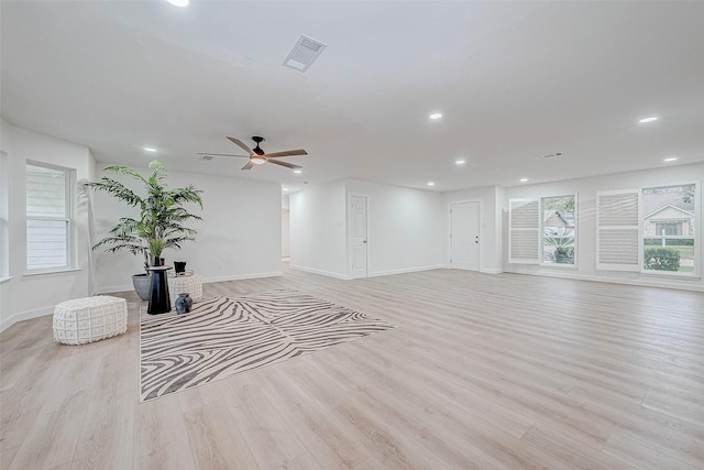 living room with ceiling fan and light hardwood / wood-style flooring