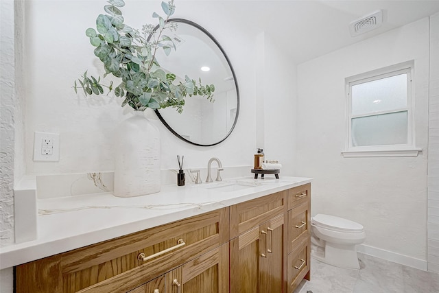 bathroom featuring vanity and toilet