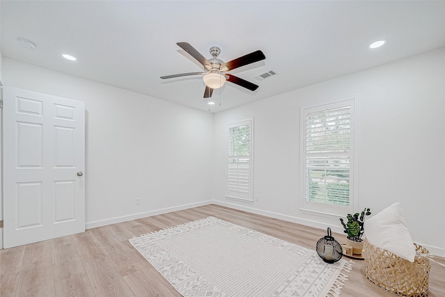 unfurnished room with ceiling fan and light hardwood / wood-style flooring