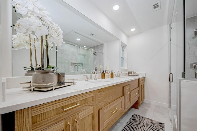 bathroom featuring tile patterned flooring, vanity, and a shower with shower door