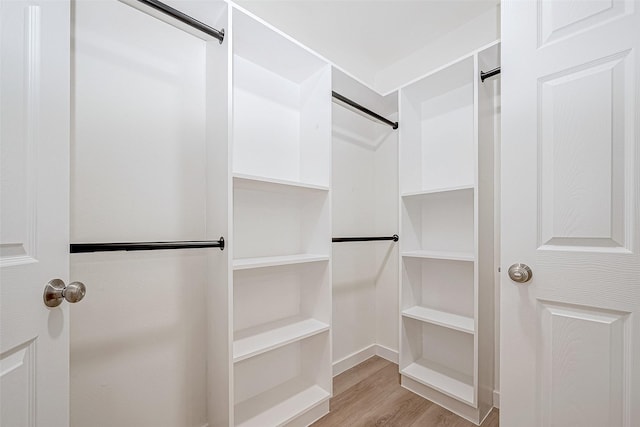 spacious closet with light hardwood / wood-style floors